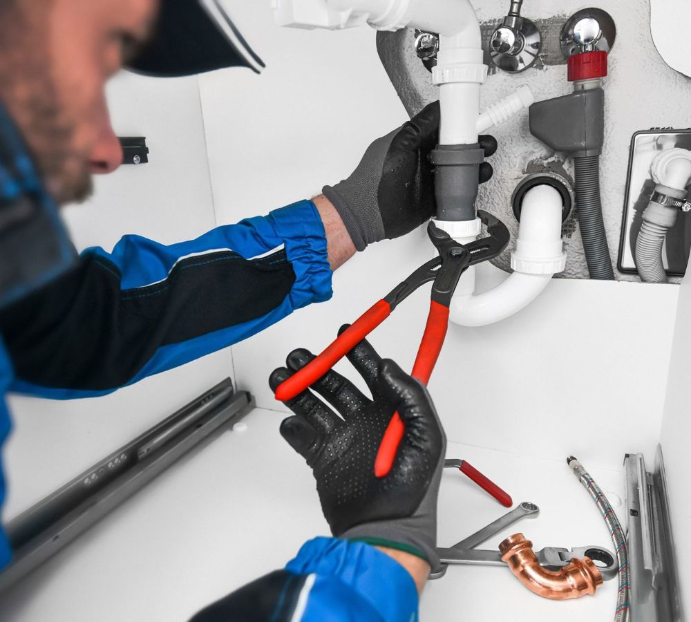 Plumber working on a residential plumbing system